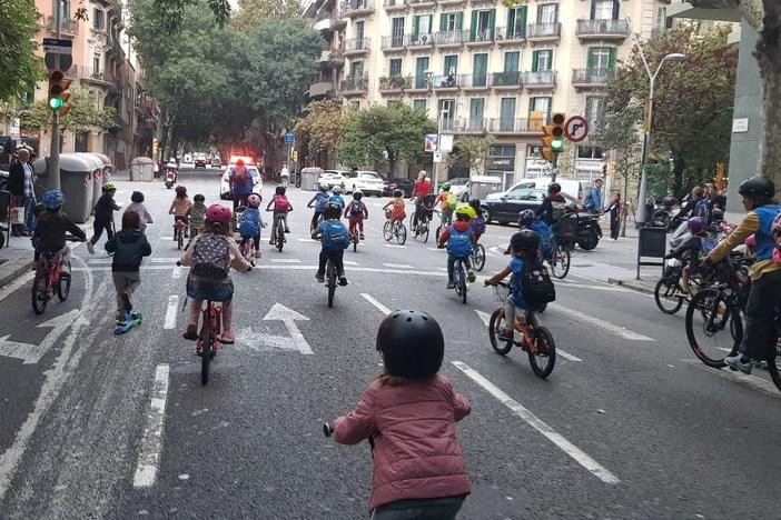 Children joining the <em>bicibús</em> in the Eixample district of Barcelona, Spain, make their way to school on a recent Friday morning. The community is hoping to build a school-friendly bike lane for a safer commute for kids.