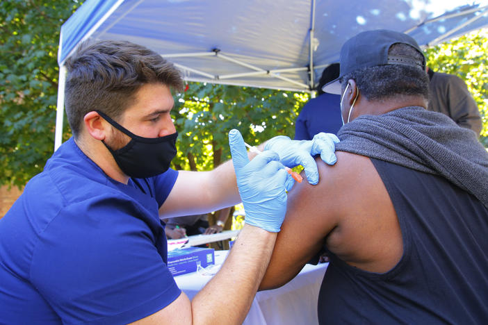 A health care worker administers a Pfizer-BioNTech COVID-19 vaccine Thursday at Life of Hope Center in New York City.