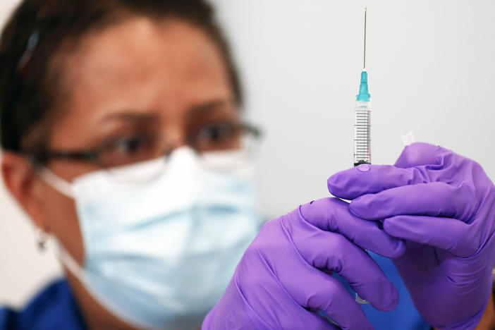 Pharmacist LaChandra McGowan prepares a dose of the Pfizer COVID-19 vaccine at a clinic operated by DePaul Community Health in New Orleans in August. Soon, children ages 5 to 11 could be eligible for Pfizer shots.