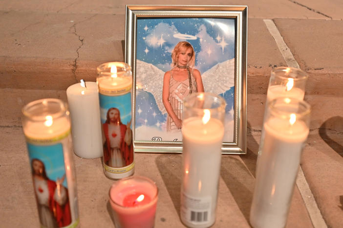 Candles surround a photo of cinematographer Halyna Hutchins during a vigil on Oct. 23 in Albuquerque, New Mexico. The American Film Institute established a scholarship in honor of Hutchins, who was killed by a prop gun on the set of the movie "Rust" last week.