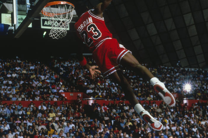 UNDATED: Chicago Bulls' forward Michael Jordan #23 dunks as the crowd takes photos during a game against the Portland Trail Blazers circa 1984-1998. (Photo by Focus on Sport via Getty Images)