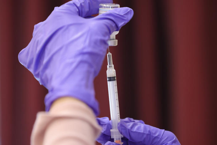 A nurse draw a Moderna COVID-19 vaccine dose from a vial at the Cameron Grove Community Center in Bowie, Md., in late March. Moderna says study data supports use of a half-dose of the vaccine in children 6 to 11.