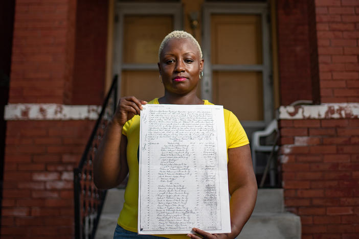 Shemia Reese holds the racial covenant that was in place for her home in St. Louis, Mo.
