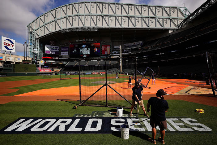 The grounds crew prepares the field during a workout prior to the start of the World Series between the Houston Astros and the Atlanta Braves at Minute Maid Park on Monday in Houston.