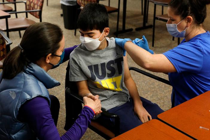 Ari Blank got a comforting hand-squeeze from his mom in May as he was vaccinated against COVID-19 in Bloomfield Hills, Mich. This week, the Food and Drug Administration authorized the use of Pfizer's vaccine in even younger kids — ages 5 to 11.