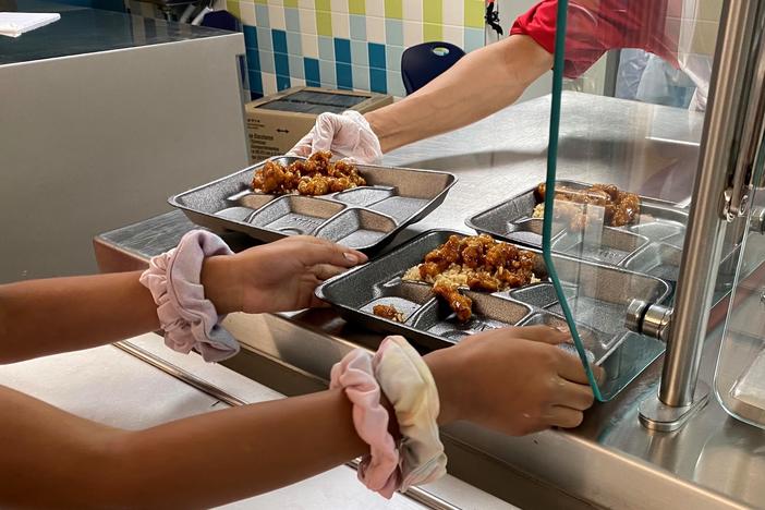 For many public school districts, meals like this Mandarin chicken at Compass Elementary in Kansas City are the culmination of a kind of treasure hunt to source food.