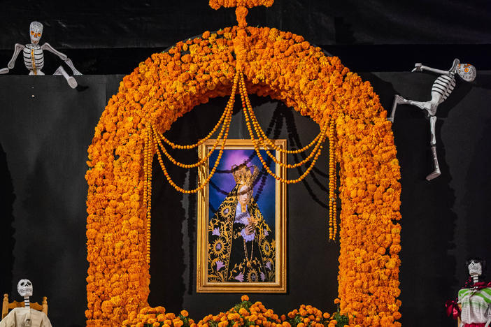 This Día de los Muertos altar on display at a public shrine in Oaxaca, Mexico, shows several traditional <em>ofrendas</em>, including <em>cempasúchil --</em> the Aztec name of the marigold flower native to Mexico.