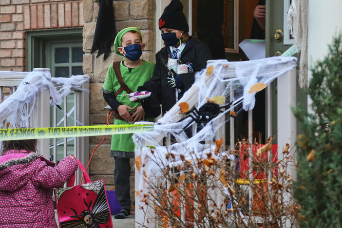 Children wear face masks to protect them during the pandemic while trick-or-treating on Halloween night in Thornhill, Ontario, Canada, on Oct. 31, 2020.