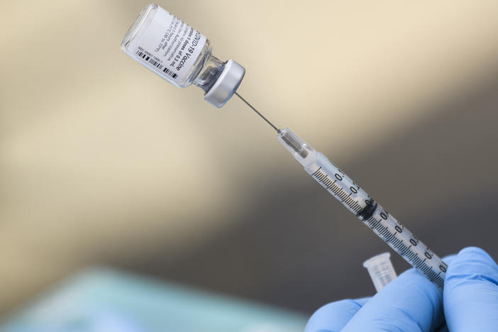A syringe is filled with a dose of the Pfizer-BioNTech COVID-19 vaccine. While the vaccine has now been authorized for children between ages 5 and 11, it may take several weeks for shots to become widely available.