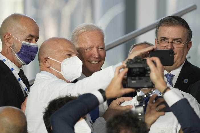 President Biden poses for a selfie with first responders who joined world leaders Saturday for the traditional family photo at the G-20 summit in Rome.