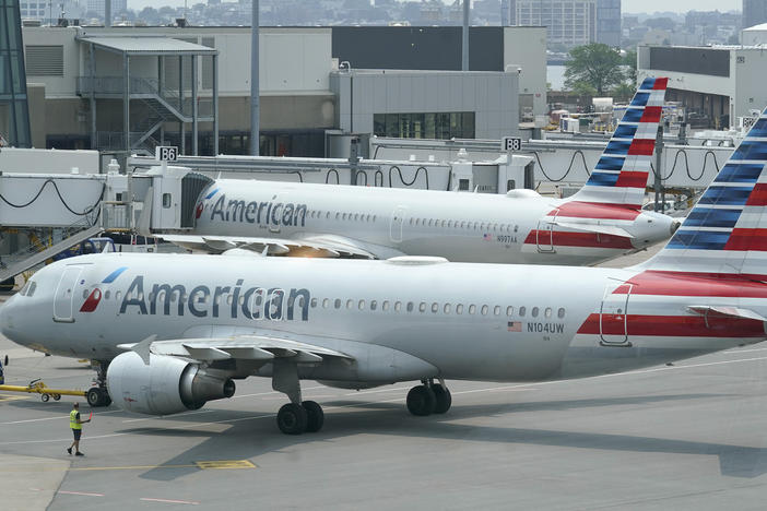 American Airlines passenger jets prepare for departure near a terminal at Boston Logan International Airport, in Boston in July. More than 1,000 flights were canceled this weekend due to weather and staffing shortages, the airline said.