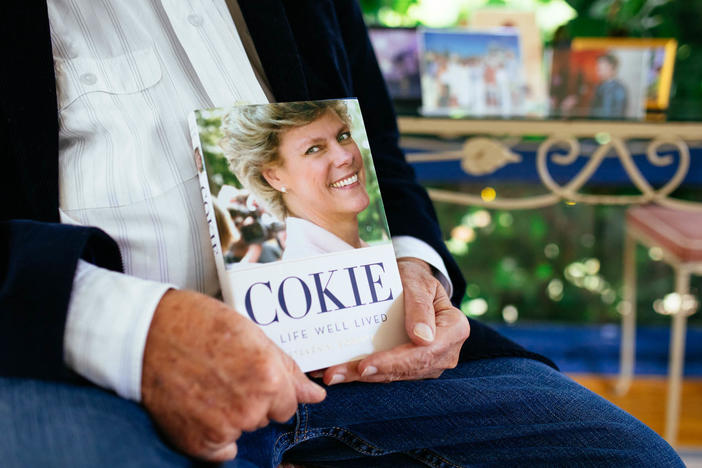 Steven Roberts holds a copy of his book <em>Cokie: A Life Well Lived</em> at his home in Bethesda, Md. The process of writing that book, he says, has helped him feel like he gets to spend more time with his wife.