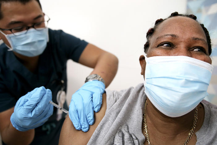 An in-home care worker receives her first dose of the COVID-19 vaccine in February in Los Angeles, Calif.