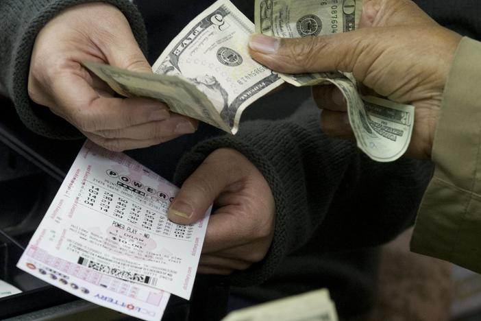 A customer purchases Powerball lottery tickets in Washington in 2012. The Maryland Lottery says a retired utility worker has won a $2 million prize for the second time since 2018.