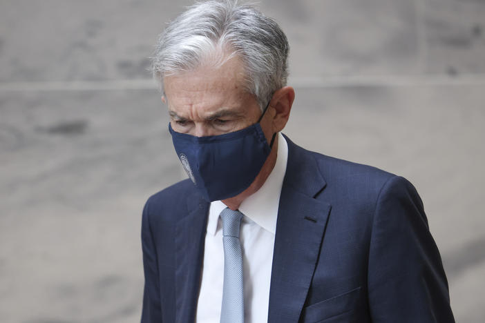 Federal Reserve Chairman Jerome Powell walks between meetings with senators on Capitol Hill on Oct. 6 in Washington, D.C. The Fed kept its interest rates near zero at the end of its policy meeting on Wednesday and announced a plan to start removing some of the support it's providing to the economy.