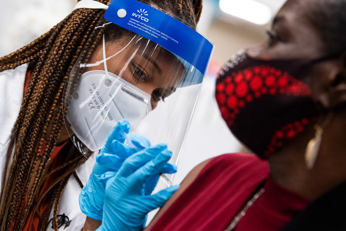 Hattie Pierce, 75, receives a Pfizer covid-19 vaccine booster shot from Dr. Tiffany Taliaferro at the Safeway on Capitol Hill in Washington, D.C., on Monday, October 4, 2021.