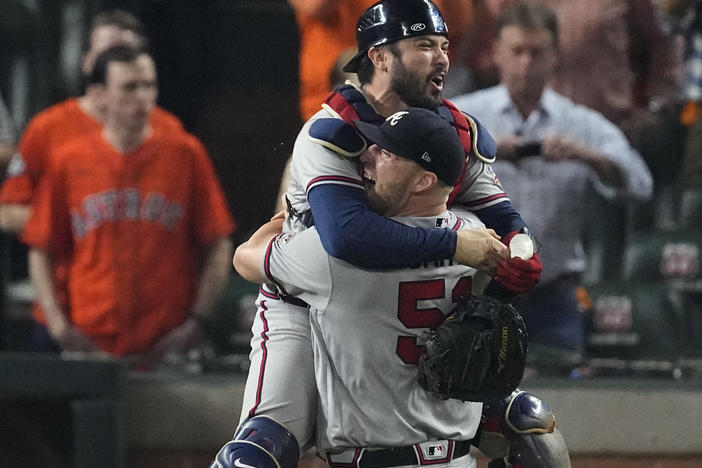 Atlanta Braves relief pitcher Will Smith and catcher Travis d'Arnaud celebrate after winning baseball's World Series in Game 6 against the Houston Astros Tuesday, in Houston. The Braves won 7-0.