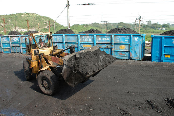 A bulldozer loads coal onto railway wagons at the Jharia coalfield in Dhanbad in India's Jharkhand state.