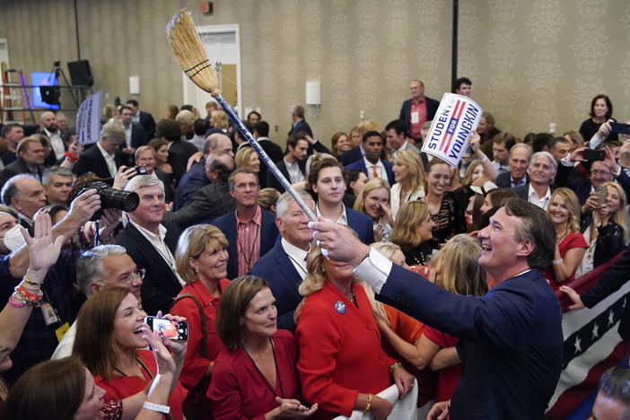 Glenn Youngkin, governor-elect of Virginia, holds a broom while greeting attendees after speaking during an election night event in Chantilly, Va. Youngkin defeated Democrat Terry McAuliffe in Virginia's closely watched governor's race.