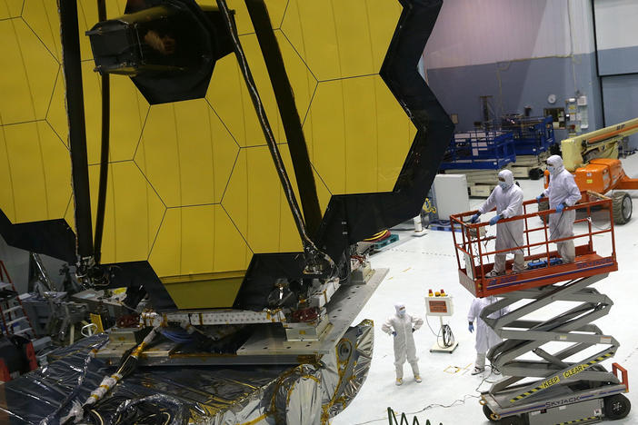 Technicians work on NASA's James Webb Space Telescope, which will launch in December. Astronomers say the next big telescope should be designed to search signs of life on planets that orbit distant stars.