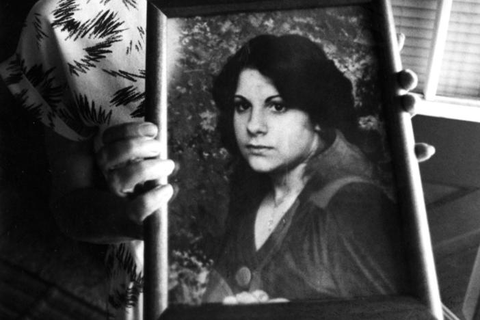 Judy Chartier holds a photograph of her missing daughter, also named Judith "Judy" Chartier, in May 1990. The car belonging to Judith and her remains were discovered nearly 40 years later.
