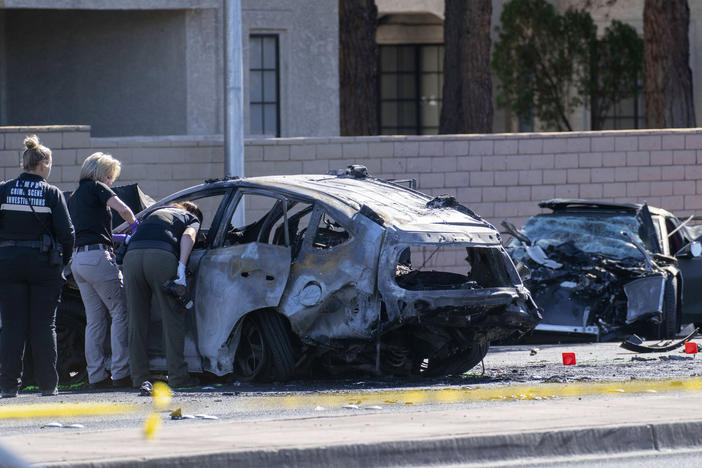 Las Vegas Metro Police investigators work at the scene of a fatal crash Tuesday. Police say Las Vegas Raiders wide receiver Henry Ruggs III was involved in a fiery crash that left a woman dead and Ruggs and his female passenger injured.