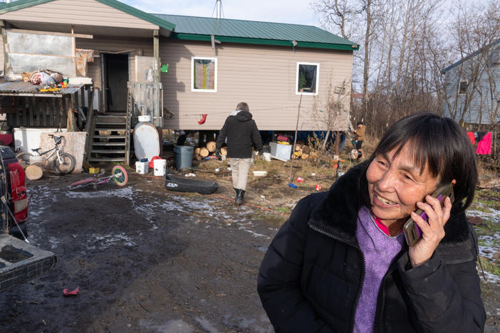 Technicians and engineers install antennae receivers on Lena Foss' home in Akiak, Alaska. Internet speeds will double in the town later this month, when it gains access to broadband internet.