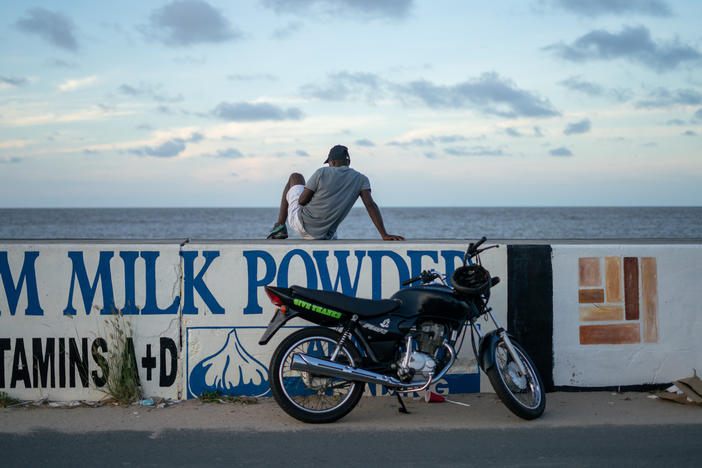 A seawall stretches for hundreds of miles along the coast of Guyana, in northern South America. It protects the low-lying coastal lands where the majority of Guyana's population lives. The region is acutely threatened by rising sea levels, as well as other symptoms of climate change, yet Guyana is embracing the oil industry.
