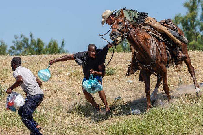 A United States Border Patrol agent on horseback tries to stop a Haitian migrant from entering an encampment on the banks of the Rio Grande near the Acuna Del Rio International Bridge in Del Rio, Texas on Sept. 19, 2021.