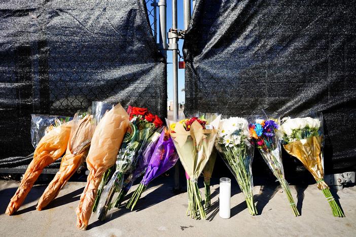 Flowers rest outside of the canceled Astroworld festival at NRG Park in Houston on Saturday. The crowd surge that killed eight people calls to mind other concerts and music festivals that turned deadly in recent decades.