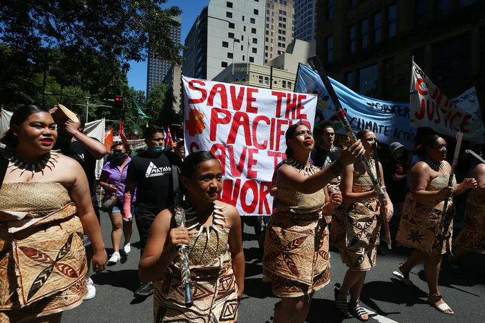 Climate activists march in Sydney during a COP26 protest on Saturday that was one of several demonstrations held around the world.