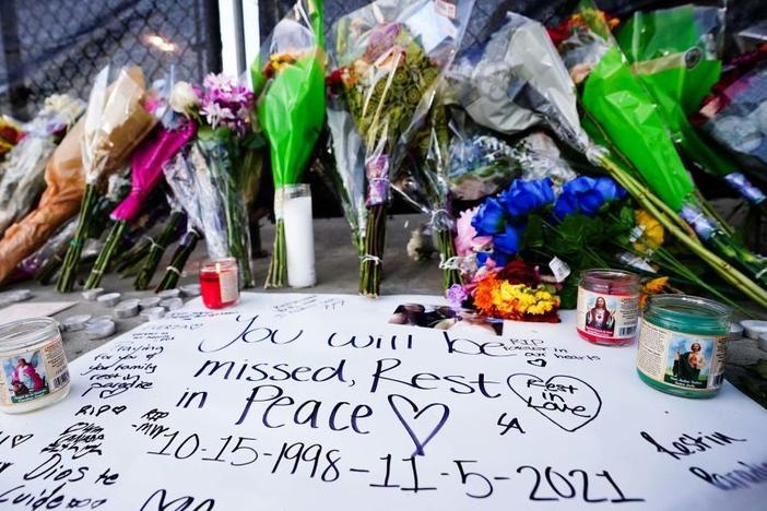 Candles, flowers and letters were placed at a memorial outside the canceled Astroworld music festival at NRG Park in Houston on Sunday.