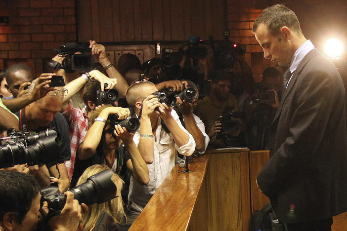 Photographers take photos of Olympic athlete Oscar Pistorius as he appears at a bail hearing for the shooting death of his girlfriend Reeva Steenkamp, in Pretoria, South Africa, Feb 20, 2013. Eight years after he shot dead his girlfriend, Pistorius is up for parole, but first he must meet with her parents as part of the parole procedure.