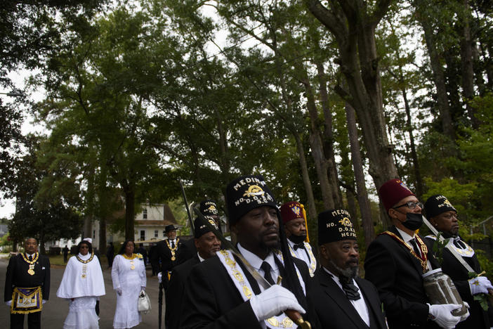 Members of the Grand Lodge of South Carolina carry soil collected in honor of Joshua Halsey to his gravesite at the Pine Forest Cemetery in Wilmington, N.C., on Nov. 6. Great-granddaughters of Halsey attended the service, where the Rev. William Barber II eulogized Halsey.