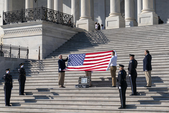 To observe the 100th anniversary of the Tomb of the Unknown Soldier, former sentinels are joined by the Ceremonial Unit of the U.S. Capitol Police for a flag folding observance at the Capitol in Washington on Wednesday. The special flag was flown over several American military cemeteries at World War I battle sites in France.