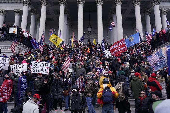 Rioters take to the steps of the U.S. Capitol on Jan. 6. An NPR analysis found more Capitol riot defendants may have ties to the Oath Keepers, a far-right group, than was previously known.