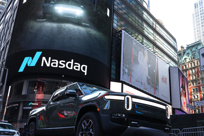 A Rivian electric truck is displayed near the Nasdaq MarketSite building in Times Square in New York City on Nov. 10. Rivian, an electric-truck maker backed by Amazon and Ford, made its debut on Nasdaq in one of the biggest initial public offerings in U.S. history.