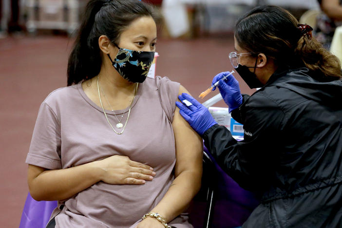 A woman receives a Pfizer vaccination booster shot from a nurse in Los Angeles. California Department of Public Health officials say that no fully vaccinated adult should be denied a COVID-19 booster shot in the state.