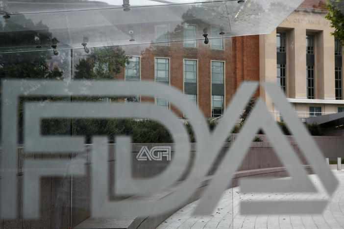 FILE - This Thursday, Aug. 2, 2018, file photo shows the U.S. Food and Drug Administration building behind FDA logos at a bus stop on the agency's campus in Silver Spring, Md.