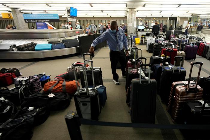 Unclaimed baggage wells up between carousels for passengers arriving on Southwest Airlines flights at Denver International Airport late Sunday, Oct. 10, in Denver.