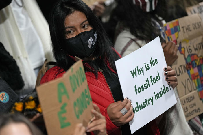 Youth climate activists protest on Thursday that representatives of the fossil fuel industry have been allowed inside the venue during the COP26 U.N. Climate Summit in Glasgow.