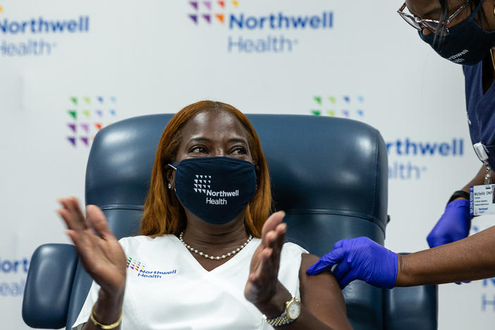 Nurse Sandra Lindsay celebrates after receiving her COVID-19 Pfizer vaccine booster at Long Island Jewish Medical Center in New York in October. Lindsay was the first person known to receive a COVID vaccine in the United States vaccination campaign — on Dec. 14, 2020. Her vaccination card is displayed at the COVID-19 exhibit in the Smithsonian Museum of American History.