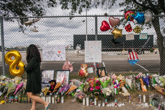 A woman walks past a memorial to those who died at the Astroworld Festival outside of NRG Park on Nov. 9, 2021 in Houston.