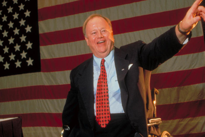 Vietnam War veteran and triple amputee Max Cleland delivers a speech during a campaign appearance. Cleland died on Tuesday at age 79.