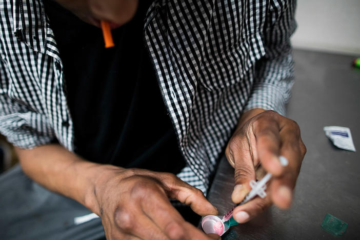 A drug user prepares to inject himself with heroin inside VANDU's supervised injection room in Vancouver, Canada. Similar sites to the ones implemented in New York have proven successful in Canada.