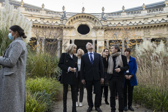 Second gentleman Douglas Emhoff looks up as he tours an exhibition at the Petit Palais museum with French first lady Brigitte Macron and artist Jean-Michel Othoniel, right.