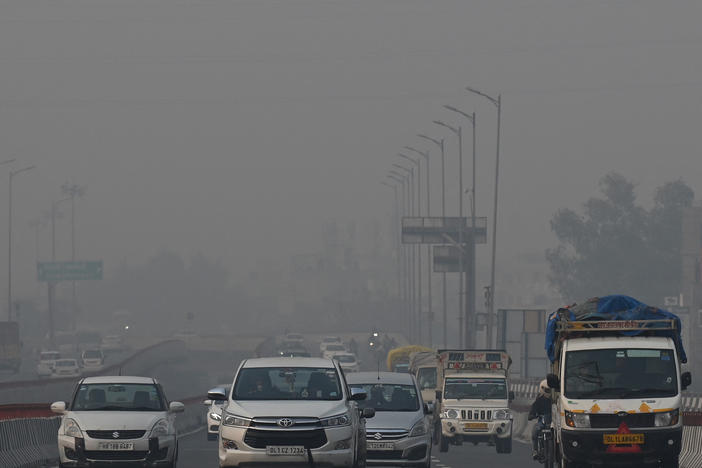 Commuters drive along a road amid heavy smog conditions in New Delhi last week.