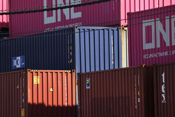 Shipping containers sit stacked at a port in Bayonne, N.J., on Oct. 15. Supply chain problems are disrupting the global economy, causing delays and a shortage of containers.