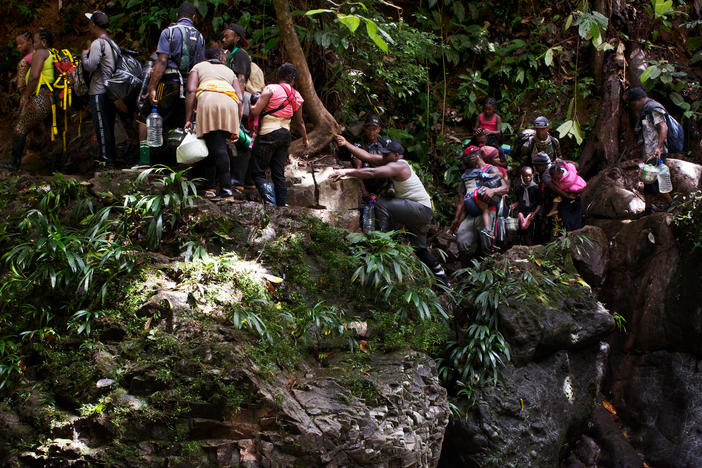 Migrants from Haiti get caught on a crevasse along the Acandiseco river, Colombia.