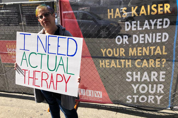 When Greta Christina heard that Kaiser Permanente mental health clinicians were staging a protest on Oct. 13, 2019, over long wait times for therapy, she made her own sign and showed up to support them. She's had to wait up to six weeks between therapy appointments for her depression.
